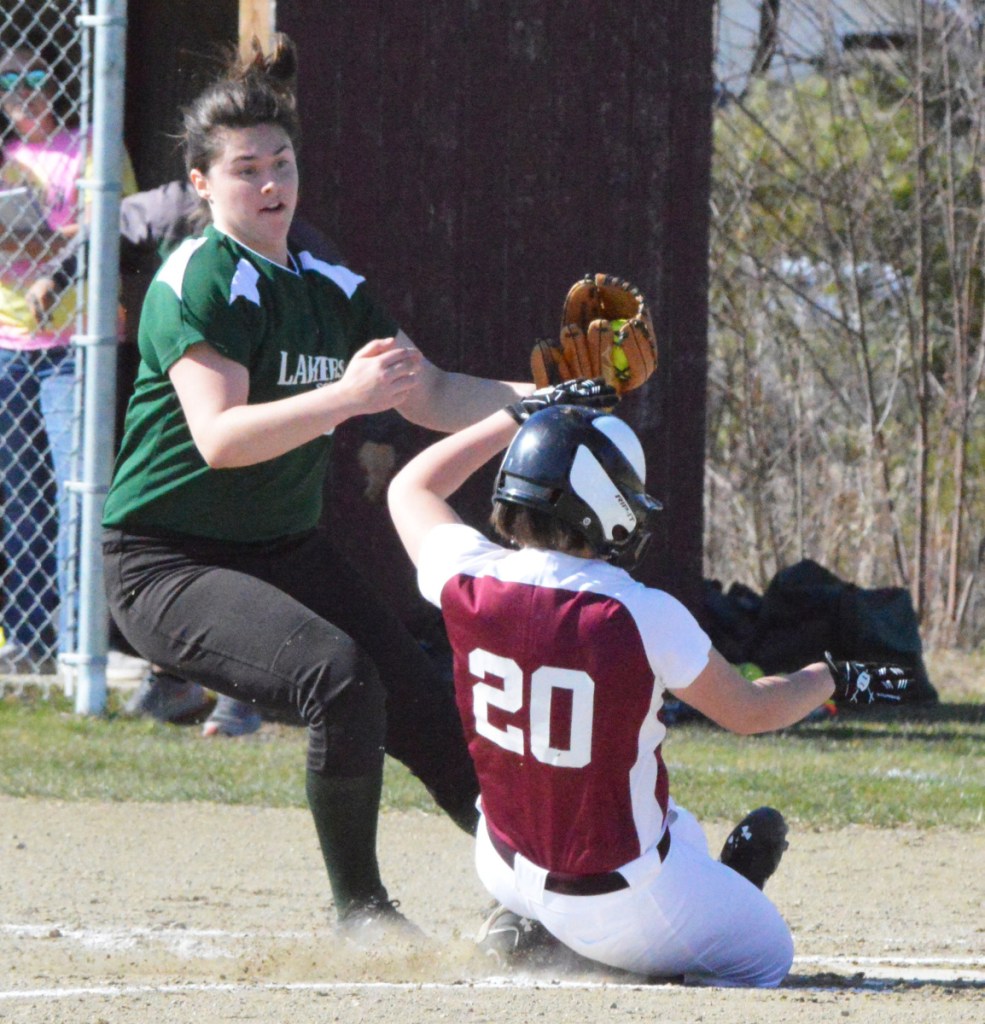 Rangeley starting pitcher Sydney Royce watches as Richmond's Paige Lebel (20) scores on a wild pitch during an East-West Conference game Tuesday in Richmond. The Bobcats rolled to a 14-0 win.