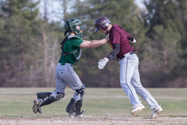 Richmond runner Matt Rines is tagged out at home by Rangeley catcher Zach Trafton during a game Tuesday in Richmond.