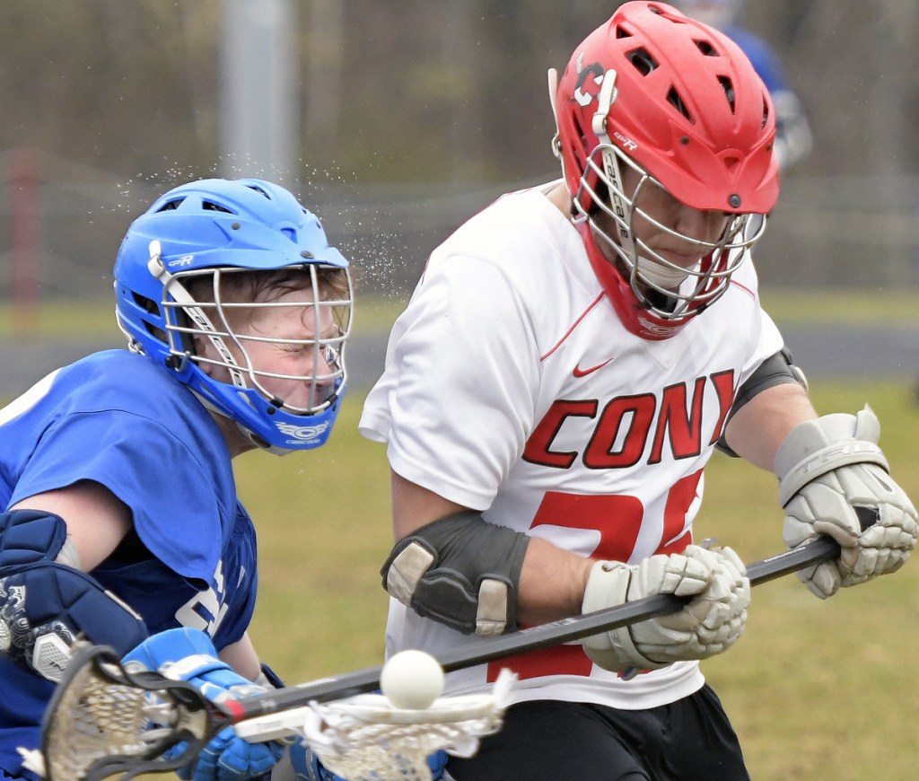 Cony's Nick Robinson, right, clips Erskine's Dakota Perkins during a lacrosse match Wednesday in Augusta.