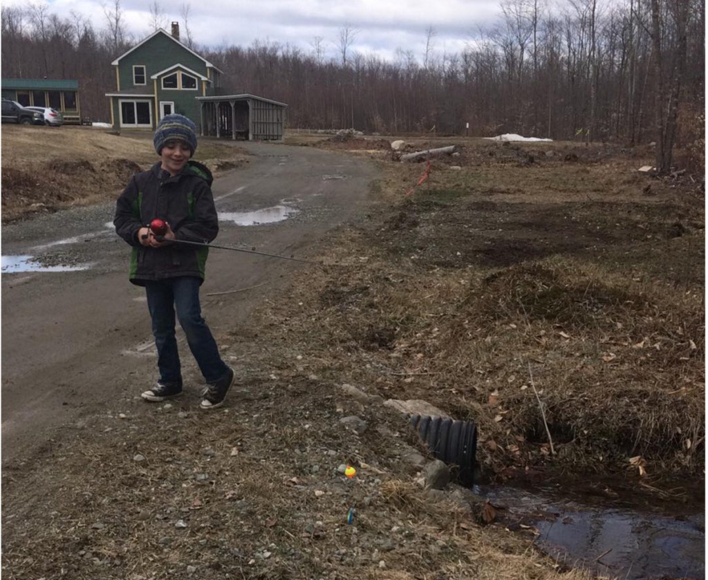 Joshuah Waugh, 8, of Canaan, works on his fishing skills in his driveway.