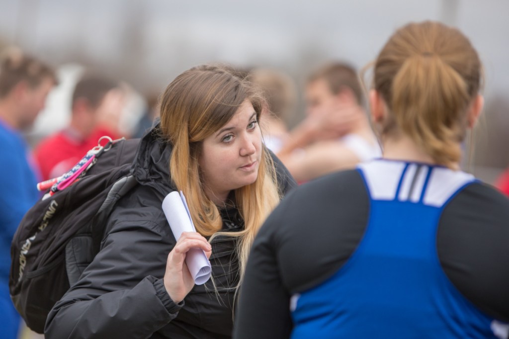 Photo by Jennifer Bechard 
 Erskine Academy throwing coach Meagan Hughes, sister of MCI thrower Allison Hughes, talks with one of her athletes at the Husky Throwdown on Saturday in Pittsfield.