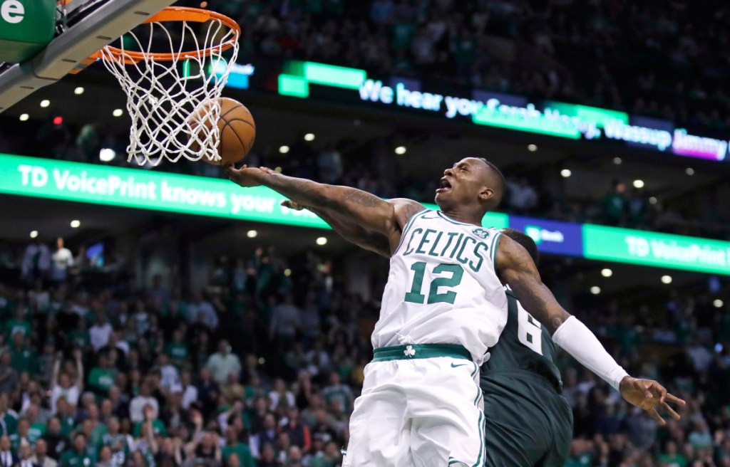 Boston's Terry Rozier (12) drives to the basket against Milwaukee during the fourth quarter of Game 7 of a first-round playoff series Saturday in Boston. Rozier scored 26 points in the Celtics' 112-96 win.