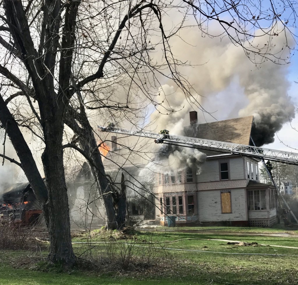 A fire burns a three-story building at 10 West St. in Gardiner on Monday afternoon.