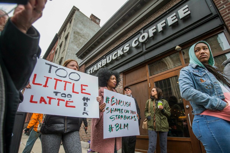 Protesters gather outside of a  Starbucks in Philadelphia on Sunday, where two black men were arrested Thursday after employees called police to say the men were trespassing. The arrest prompted accusations of racism on social media. Starbucks CEO Kevin Johnson posted a lengthy statement Saturday night, calling the situation "disheartening" and that it led to a "reprehensible" outcome. 