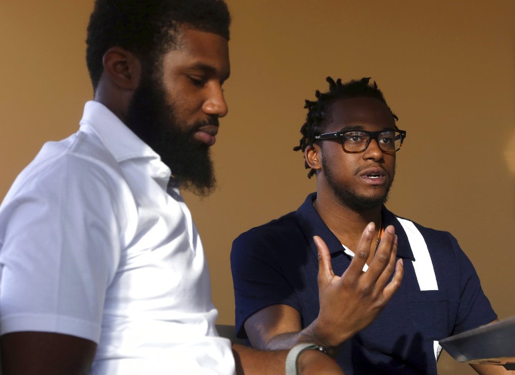 Rashon Nelson, left, listens as and Donte Robinson, right, addresses a reporter's question during an interview with The Associated Press in Philadelphia on Wednesday. 