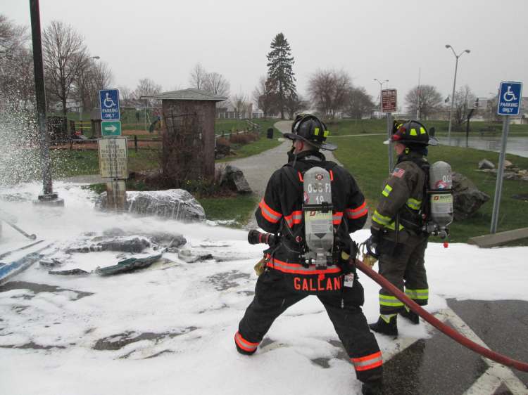 Firefighters extinguish a fire that ignited two portable toilets in an Old Orchard Beach park on Friday.