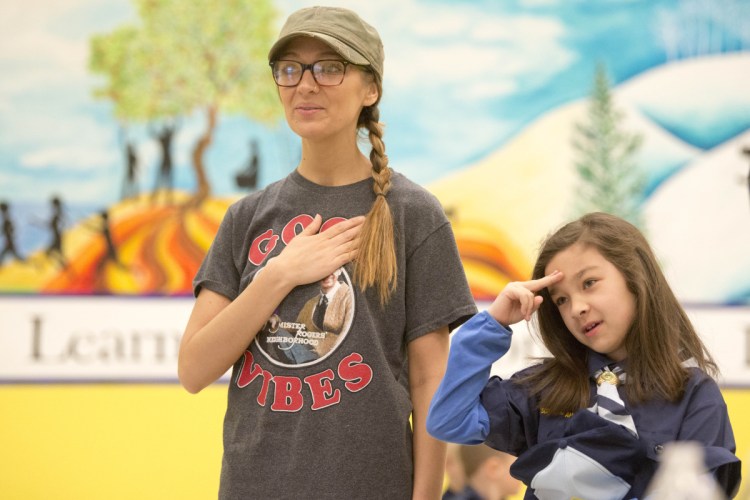 Natalie To, 8, says the Pledge of Allegiance with her mother Christina Ames during a Kennebec County Cub Scout pack meeting at Williams Elementary School in Oakland on Tuesday.