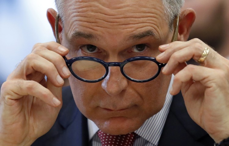 EPA Administrator Scott Pruitt removes his glasses during a hearing on Capitol Hill in April.