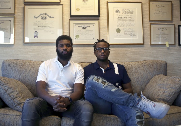 Rashon Nelson, left, and Donte Robinson, both 23, pose for a portrait in Philadelphia in April. The two black men, arrested for sitting at a Starbucks cafe in Philadelphia without ordering anything, settled with the city of Philadelphia for a symbolic $1 each Wednesday, and a promise from city officials to set up a $200,000 program for young entrepreneurs.