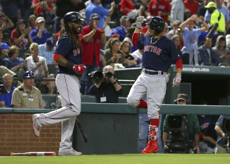 Boston's Hanley Ramirez, left, does a celebratory dance with Mookie Betts after Betts' solo home run in the sixth inning Friday night at Arlington, Texas.