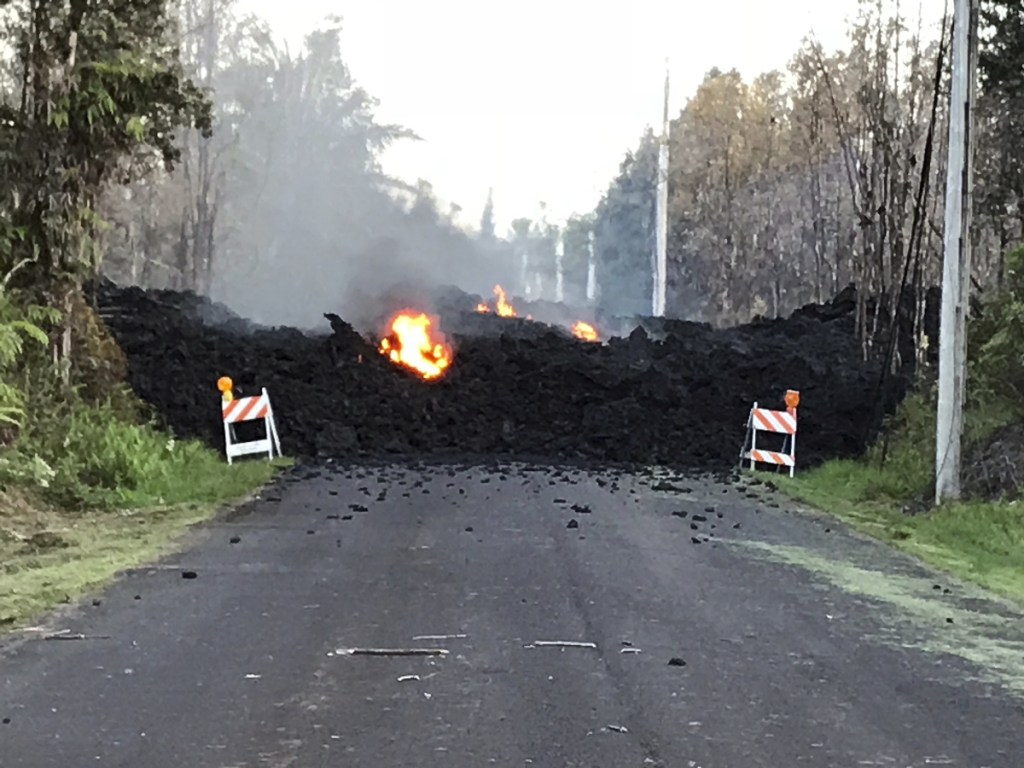 This photo provided by Hawaii Electric Light shows Mohala Street in Leiliani Estates near the town of Pahoa on Hawaii's Big Island that is blocked by a lava flow from the eruption of Kilauea volcano.