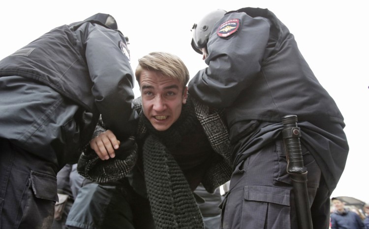 Police arrest a protester in St. Petersburg, Russia. Thousands gathered to protest the re-election of President Vladimir Putin, who won another term with 77 percent of the vote.