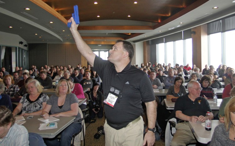 Clark Aposhian, president of the Utah Shooting Sport Council, holds a plastic gun during a concealed weapons training session for Utah teachers in 2012.