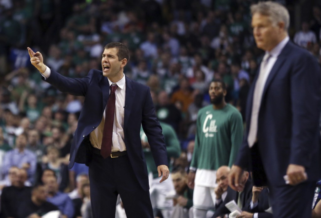 Boston Celtics coach Brad Stevens yells to his team as Philadelphia 76ers coach Brett Brown watches at right during the second half of Game 2 of an NBA basketball second-round playoff series, Thursday, May 3, 2018, in Boston. The Celtics won 108-103. (AP Photo/Elise Amendola)