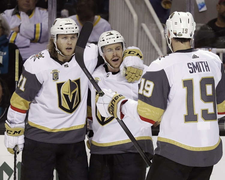 Jonathan Marchessault, center, celebrates his goal with Vegas teammates William Karlsson, left, and Reilly Smith during the Golden Knights' 3-0 win Sunday over Nashville.