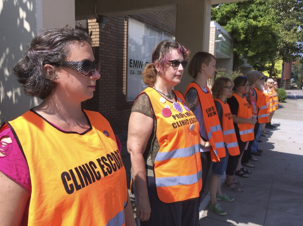 Escort volunteers line up outside the EMW Women's Surgical Center in Louisville, Ky., last July. A federal judge established a buffer zone outside the clinic to keep anti-abortion protesters from assembling in front of the entrance, after at least 10 protesters were arrested for blocking it earlier in the month.