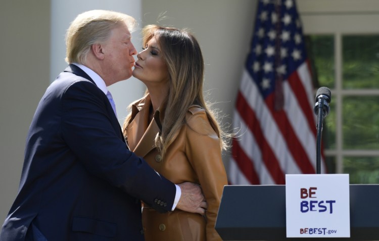 President Trump kisses first lady Melania Trump after Mrs. Trump announced her initiatives in the Rose Garden of the White House in Washington on Monday. The first lady formally launched her long-awaited initiative after more than a year of reading to children, learning about babies born addicted to drugs and hosting a White House conversation on cyberbullying.
