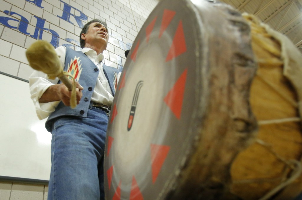 A member of the Penobscot Nation chants and beats a drum in 2013 at a Kennebunk school during a weeklong program about Native American culture and traditions. The University of Maine and the Penobscot Nation have signed an agreement to help preserve the tribe's cultural heritage.
