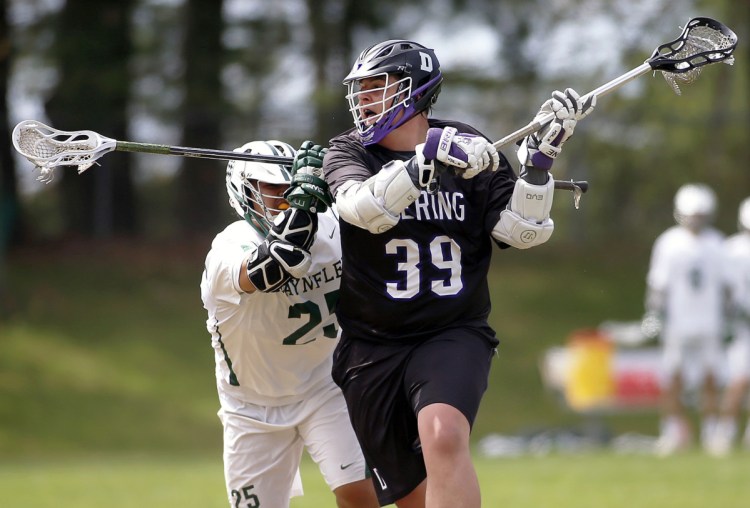 Deering's Payson Harvey winds up for a shot while defended by Makany Parr of Waynflete. Harvey scored three goals, but Waynflete rallied for a 12-11 win.