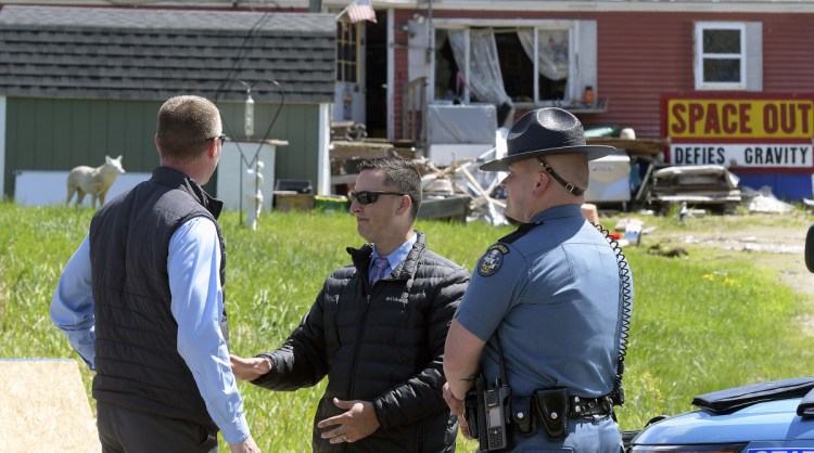 Maine State Police stand outside a mobile home in Wales on Monday where 54-year-old William N. Derick, who lived in there at 485 Pond Road, was shot and killed by State Trooper James MacDonald.