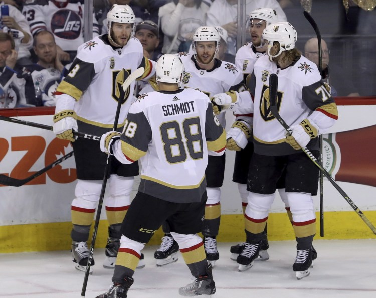 Vegas players gather to celebrate after a goal by Jonathan Marchessault, center, during the Golden Knights' 3-1 win in Game 2 of the Western Conference finals on Monday.