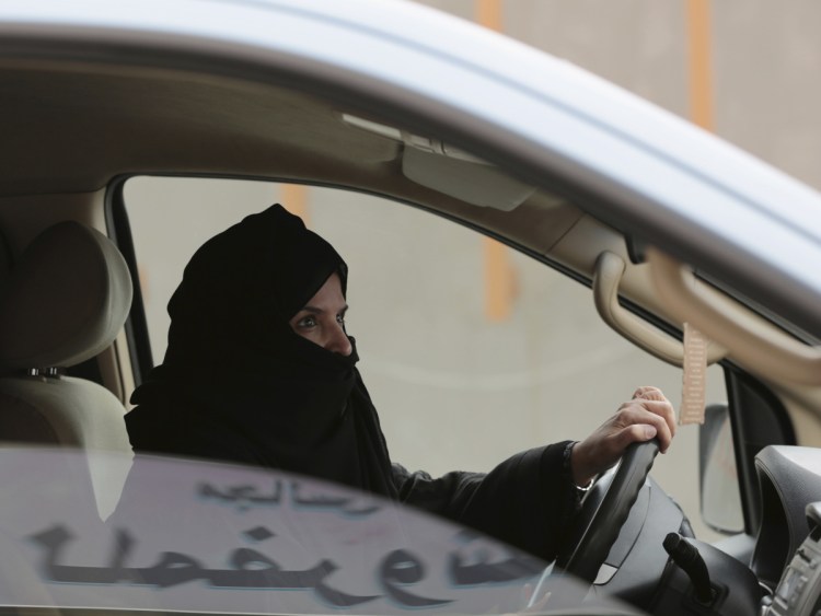 Aziza al-Yousef drives a car in Riyadh in 2014 as part of a campaign to defy Saudi Arabia's ban on women driving.