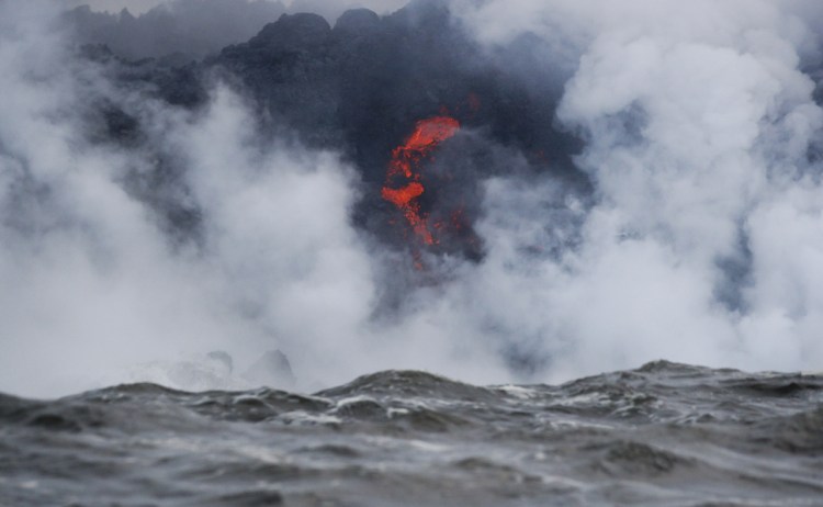 Lava flows into the ocean near Pahoa, Hawaii, on Sunday. Kilauea volcano on Hawaii's Big Island has gotten more hazardous in recent days, with rivers of molten rock pouring into the ocean and flying lava causing the first major injury.