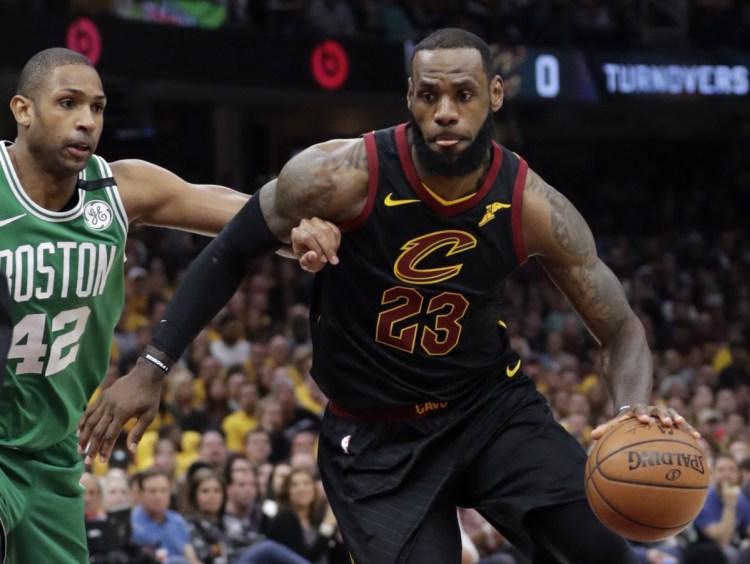 Cleveland's LeBron James drives past Boston's Al Horford in the first half of Game 4 of the Eastern Conference finals on Monday in Cleveland. The Cavaliers won 111-102 to tie the series at 2-2.