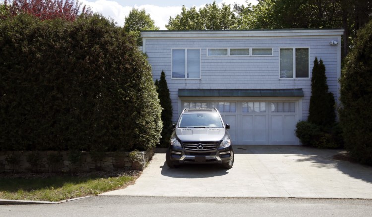 A Mercedes sits in the driveway of Stephen Mardigan's $985,000 home on Baxter Boulevard. An assistant U.S. attorney said he is not aware of a larger gambling-related case in Maine than Mardigan's in terms of the length of the operation and the total amount wagered. William Flynn was a player in  Mardigan's high-stakes gambling business in Portland from 2010 to 2017.