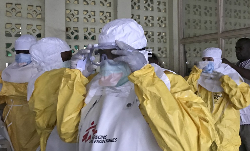A team from Doctors Without Borders)dons protective clothing Sunday as they prepare to treat Ebola patients.