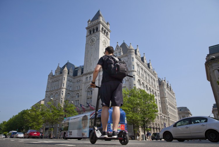 A man rides a Bird electric scooter along Pennsylvania Avenue in front of the Trump International Hotel in downtown Washington earlier this month.