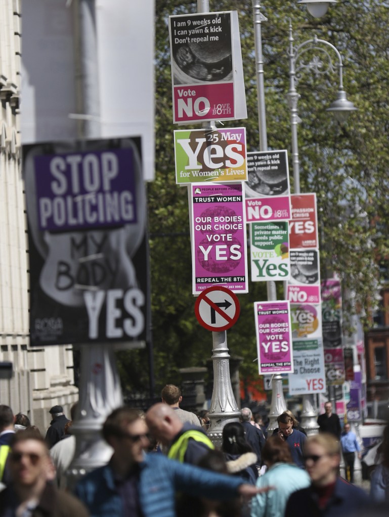 Pro- and anti-abortion posters are displayed on lampposts outside government buildings in Dublin, Ireland, on May 17. Irish voters went to the polls Friday to decide whether to repeal a constitutional ban on abortion.