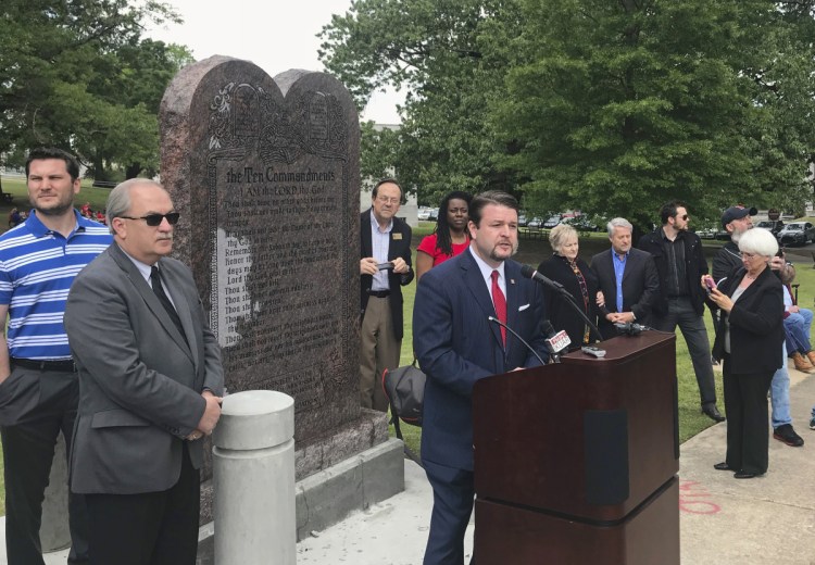 Arkansas Republican state Sen. Jason Rapert speaks at the unveiling of a Ten Commandments monument outside the Arkansas state Capitol in Little Rock in April. Opponents of the display filed lawsuits Wednesday to have the monument removed, arguing it's an unconstitutional endorsement of religion by government. A 2015 law required the state to allow the privately funded monument.
