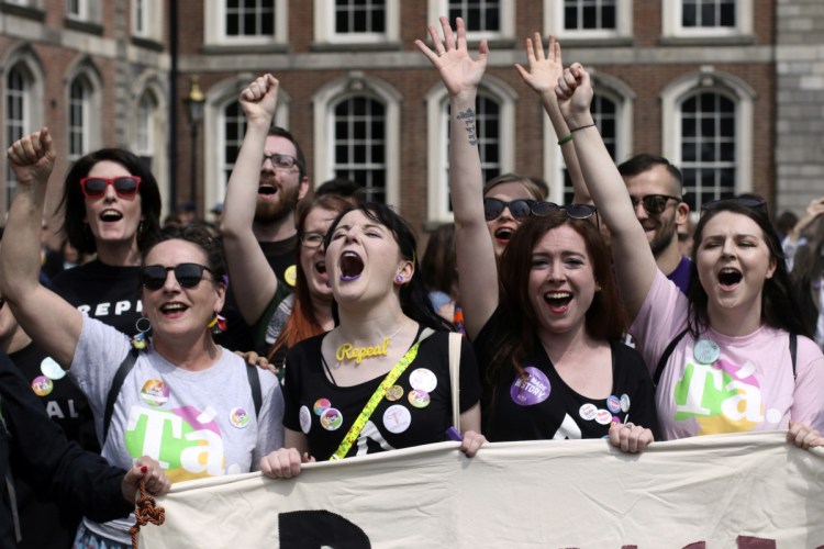 People from the yes campaign react at Dublin Castle in Dublin, Ireland, on Saturday as the results of the votes begin to come in.
