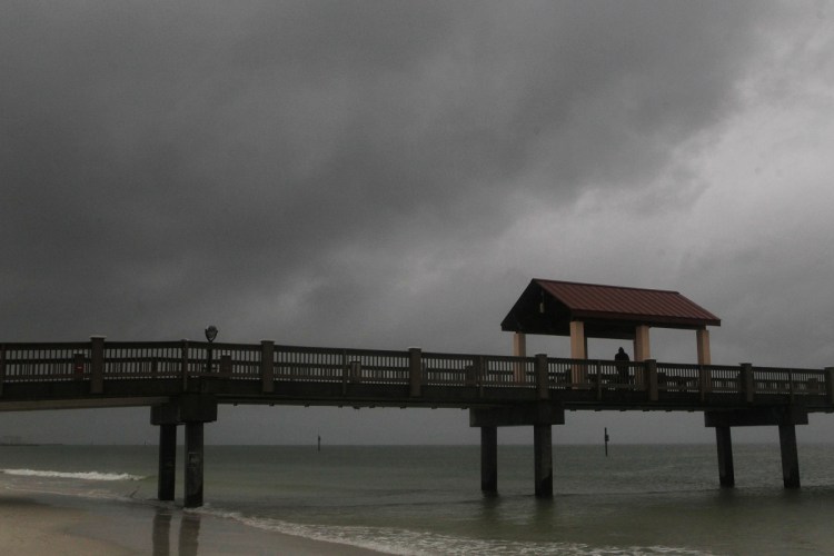 Rain falls on Clearwater Beach by Pier 60 early Sunday as Subtropical Storm Alberto looms in the Gulf to the southwest. 
 Jim Damaske/Tampa Bay Times via AP