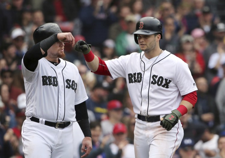 Boston's Andrew Benintendi, right, celebrates his three-run home run with teammate Christian Vazquez in the fourth inning of Boston's 8-3 win over the Toronto Blue Jays on Monday at Fenway Park in Boston.