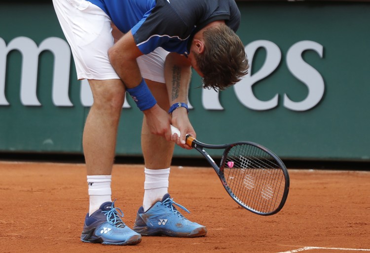 Stan Wawrinka hangs his head during his first-round loss to Guillermo Garcia-Lopez on Monday at the French Open in Paris. Wawrinka lost 6-2, 3-6, 4-6, 7-6 (5), 6-3.