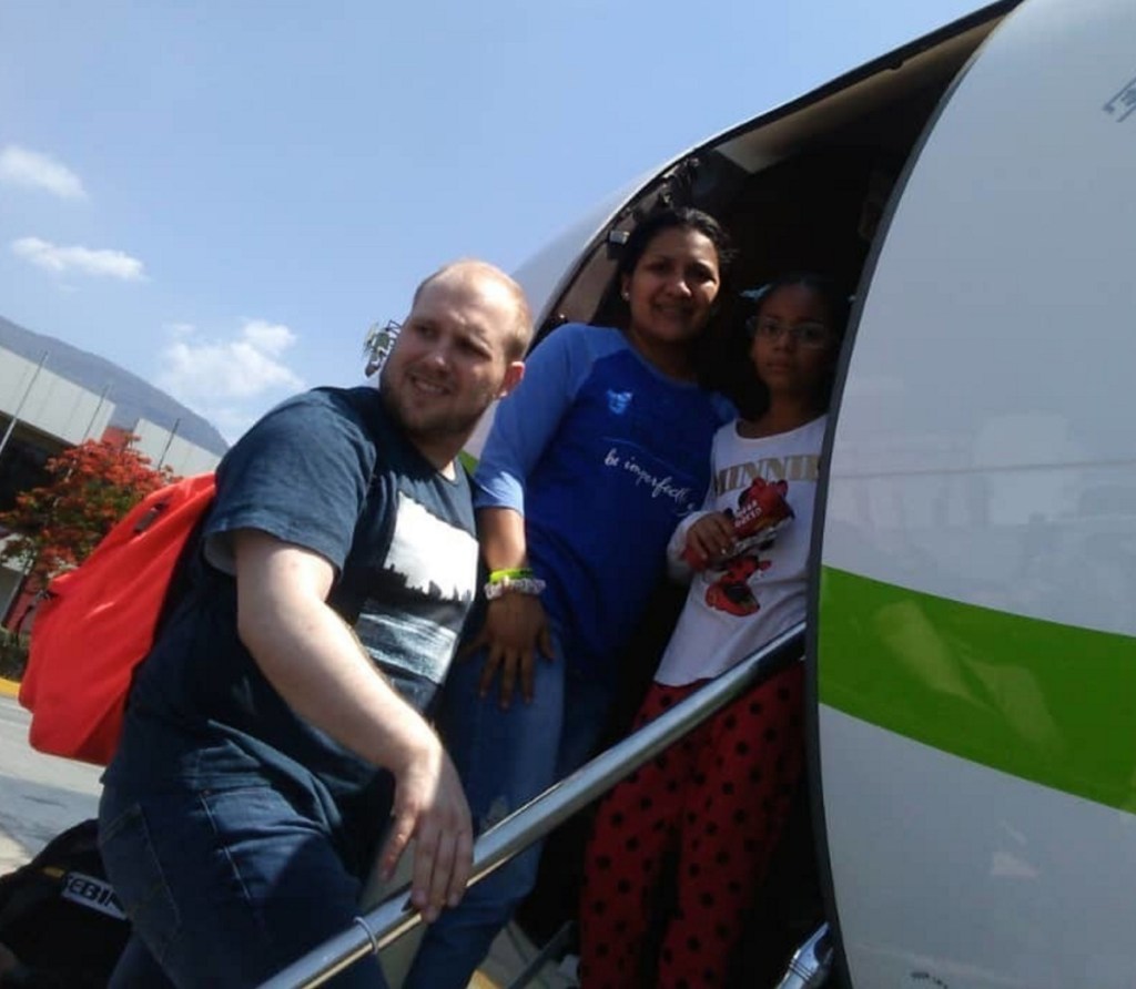 In this image provided by the Holt family, Joshua Holt, his wife, Thamara, and her daughter Marian Leal board a plane in Caracas, Venezuela, on Saturday, bound for Washington, D.C.