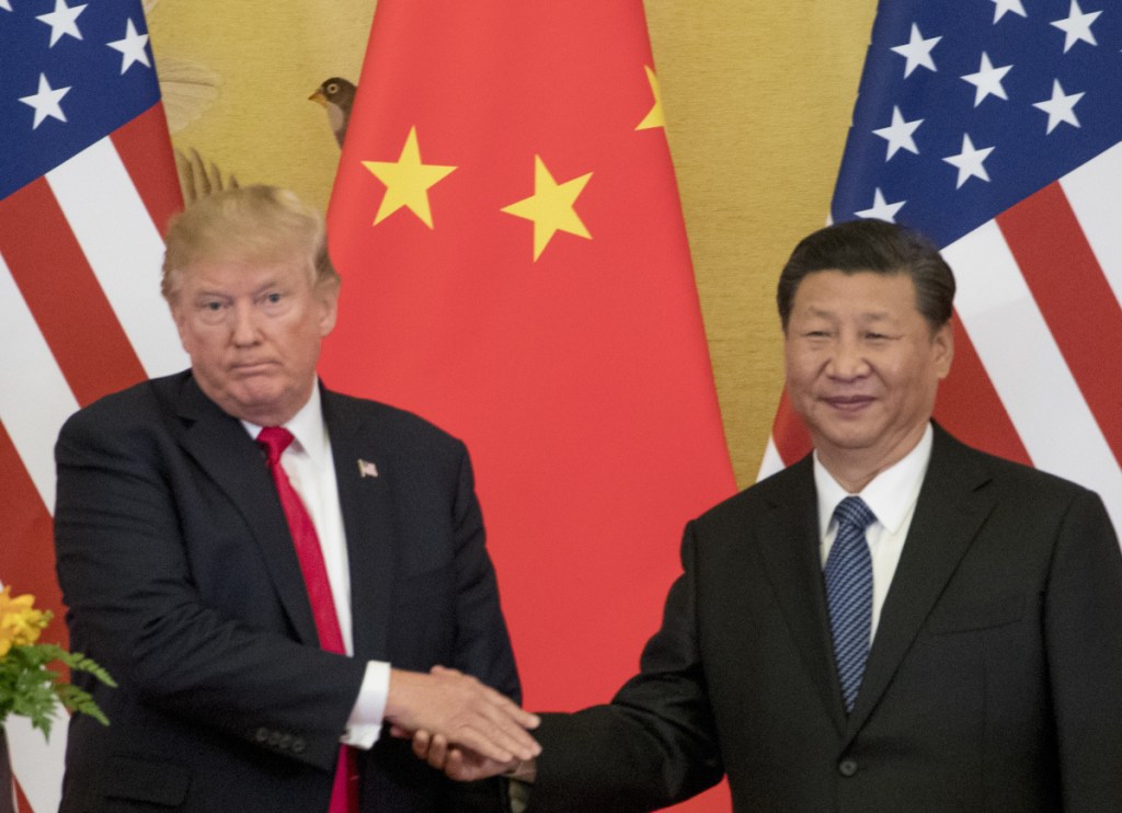 President Trump and Chinese President Xi Jinping make a joint statement to the media in November at the Great Hall of the People in Beijing. China's Ministry of Commerce responded mildly Tuesday to new U.S. threats on trade.