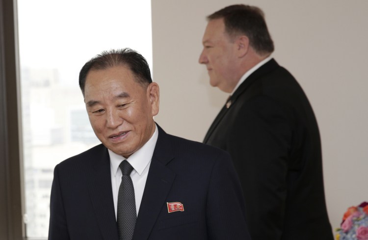 Kim Yong Chol, former North Korean military intelligence chief and one of Kim Jong Un's closest aides, and U.S. Secretary of State Mike Pompeo take their places at the table before a meeting Thursday in New York.