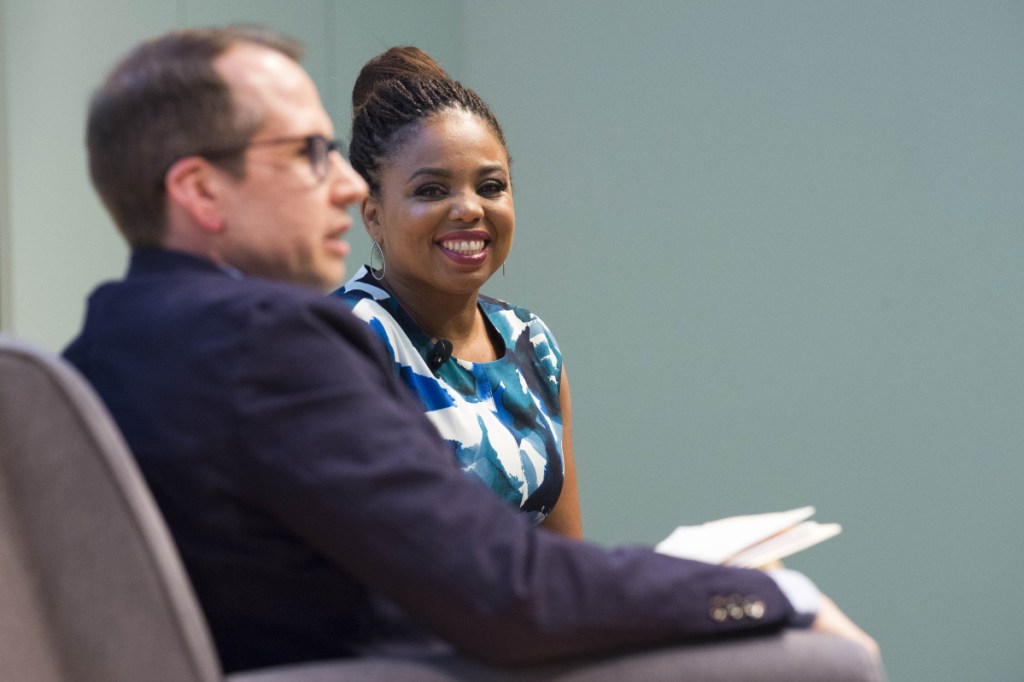 Jemele Hill, right, smiles during an introduction by Justin McCann prior to her" Freedom to Speak: A Conversation with Jemele Hill on Athletics and Activism" event Tuesday night at Ostrove Auditorium on the campus of Colby College.
