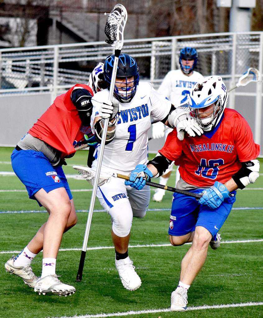 Lewiston High School's Dominick Colon (1) slices through Messalonskee defeders, including Alden Balboni, right, during their game in Lewiston on Tuesday.