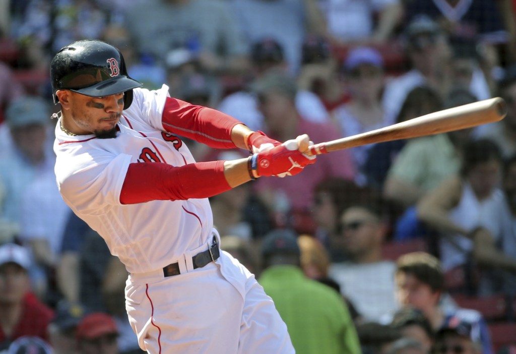 Boston Red Sox outfielder Mookie Betts hits his third home run of the game in the seventh inning Wednesday against the Kansas City Royals at Fenway Park in Boston.