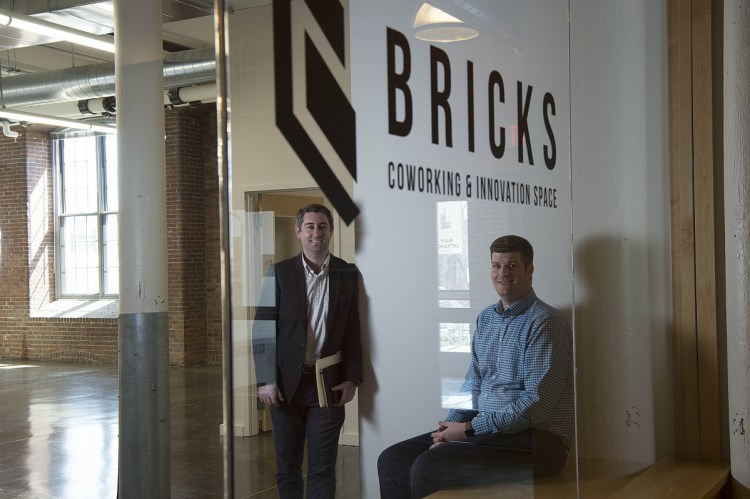 Garvan Donegan, an economic development specialist for the Central Maine Growth Council, center, and RJ Anzelc, founder of Bricks Coworking & Innovation Space and a software developer and entrepreneur, pose for a portrait Wednesday at a new rental office space at the Hathaway Center in Waterville.