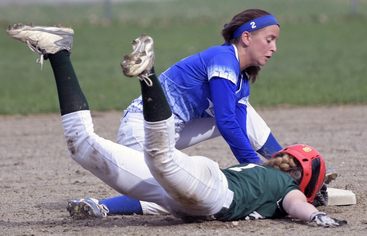 Winthrop's Bryana Baxter slides into second under a throw to Madison's Annie Worthen during a softball game on Wednesday in Winthrop.
