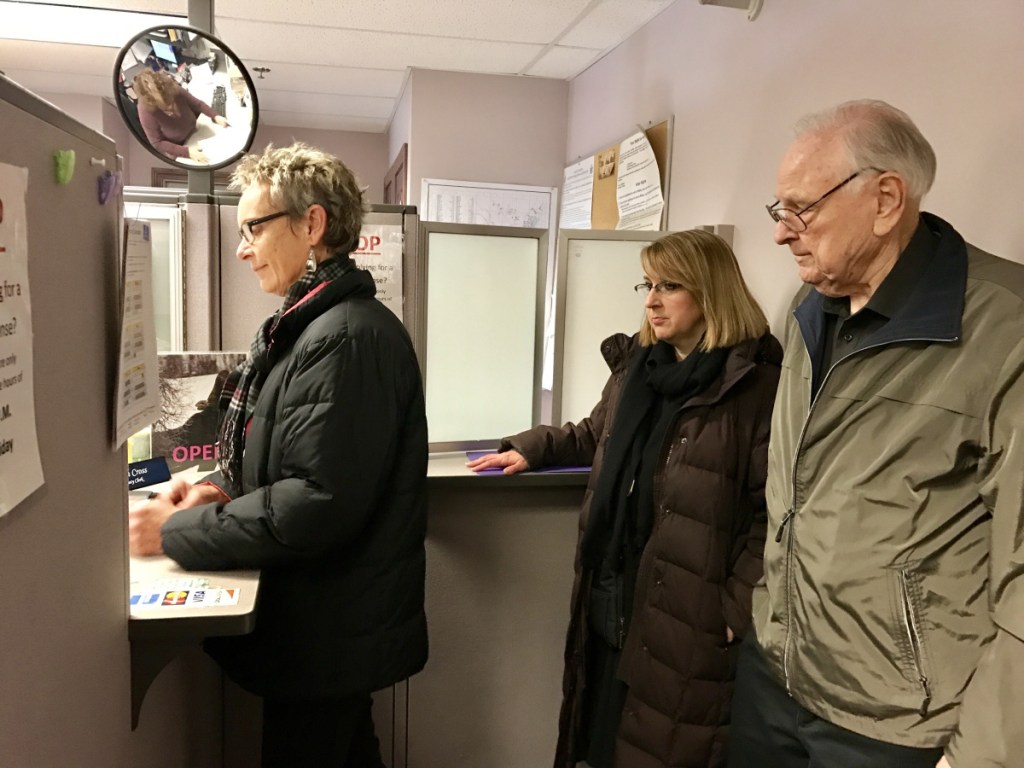 Former Waterville Mayor Karen Heck and residents Hilary Koch and Jim Chiddix take out paperwork April 9 at Waterville City Hall to start a petition to recall Mayor Nick Isgro. On Thursday, city officials certified they had gathered enough signatures to force a recall vote.