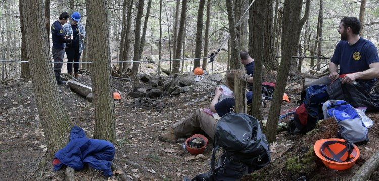Maine Conservation Corps and Americorps workers break for a meal Wednesday while building a trail at the 175-acre Augusta Nature Education Center.
