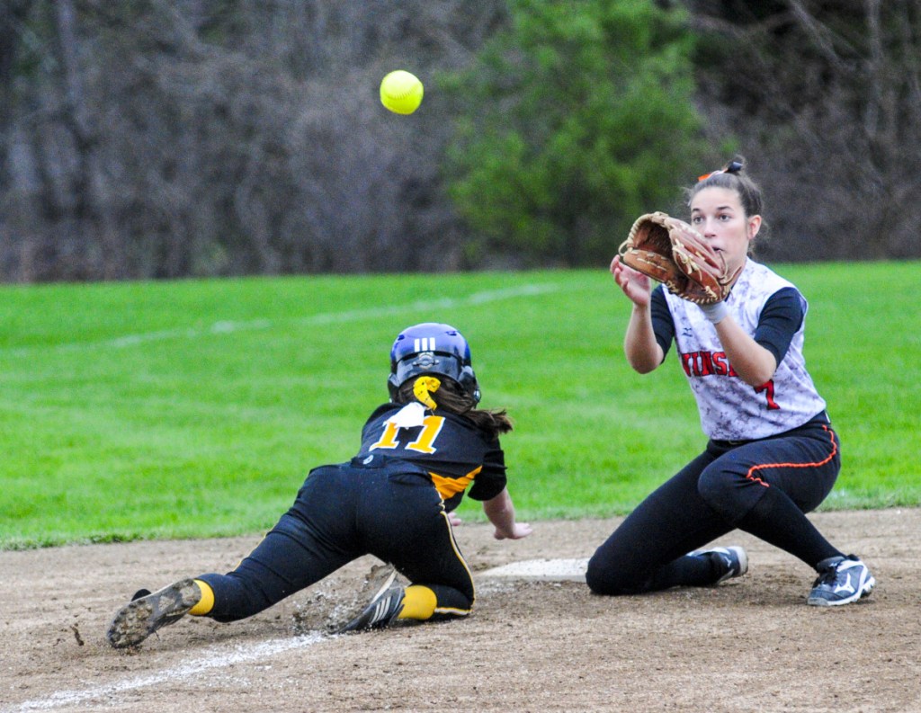 Maranacook's Kaylee Jones, left, dives back to third base in time to beat the throw to Winslow third baseman Alexa Petrovic during a game Friday in Readfield.