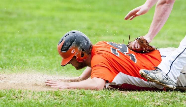 Winslow's Isaac Targett gets tagged out before he can make it back to third base as he was caught in a rundown against Maranacook on Friday in Readfield.