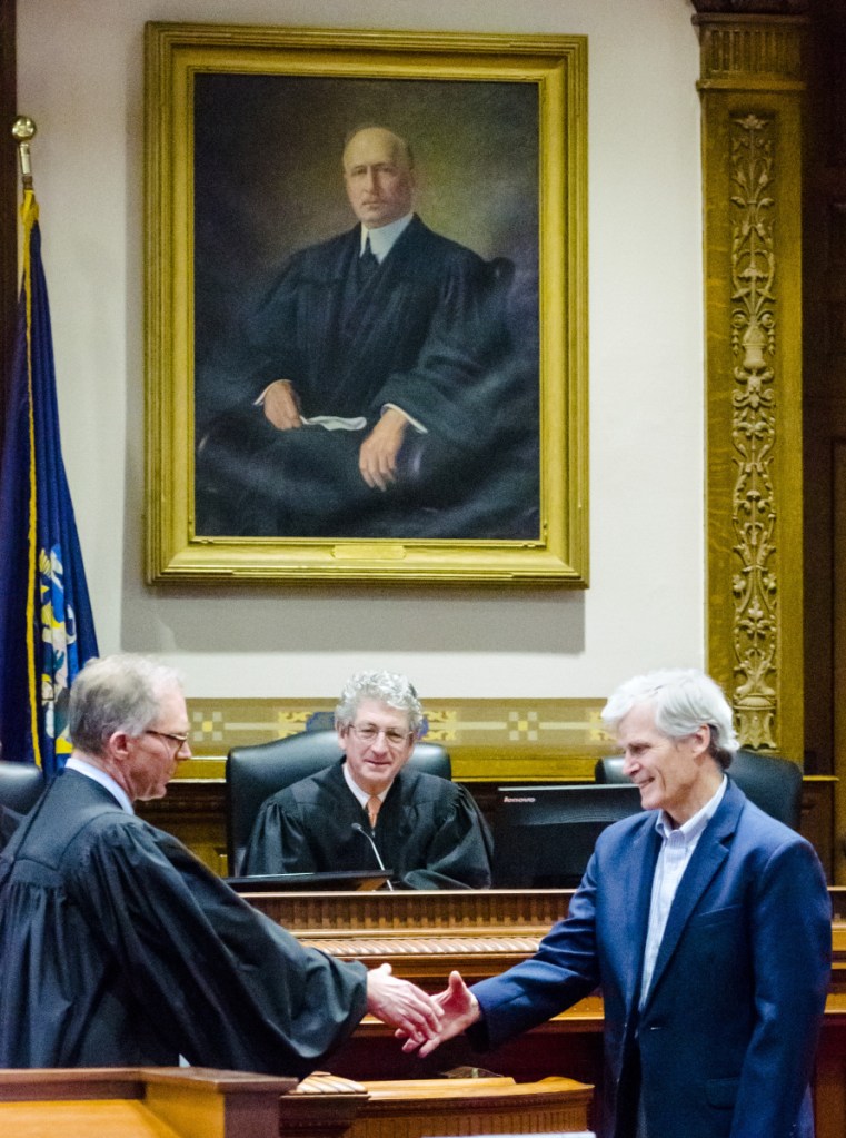 Maine Supreme Court Associate Justice Jeffrey Hjelm, left, presents James McKenna III a Katahdin Counsel award on Thursday during an event in a ceremonial court room at Capital Judicial Center in Augusta.
